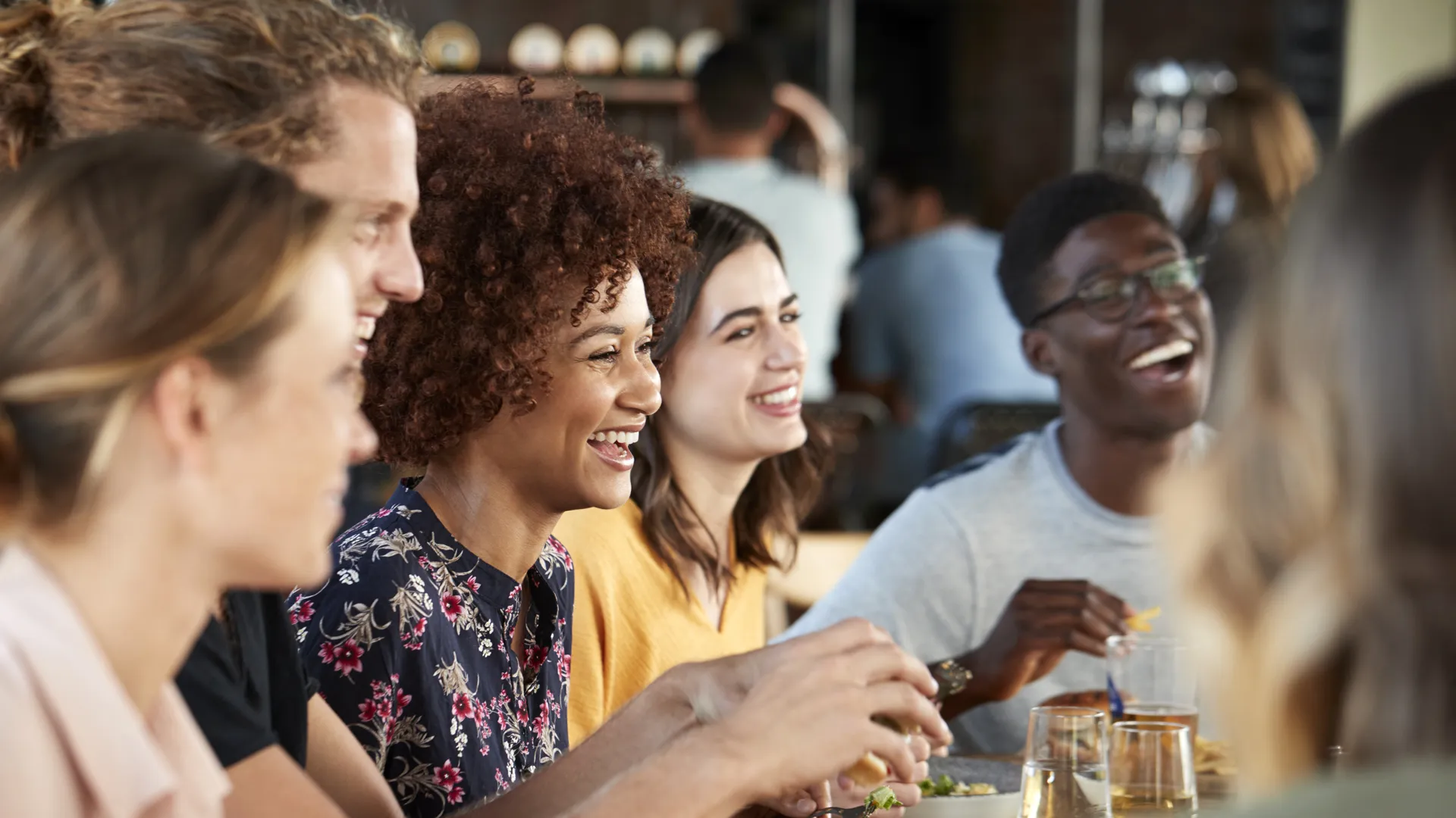 Group of friends at a packed restaurant